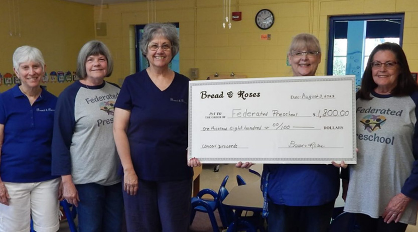 giving 2 Bread & Roses presenting concert proceeds donation